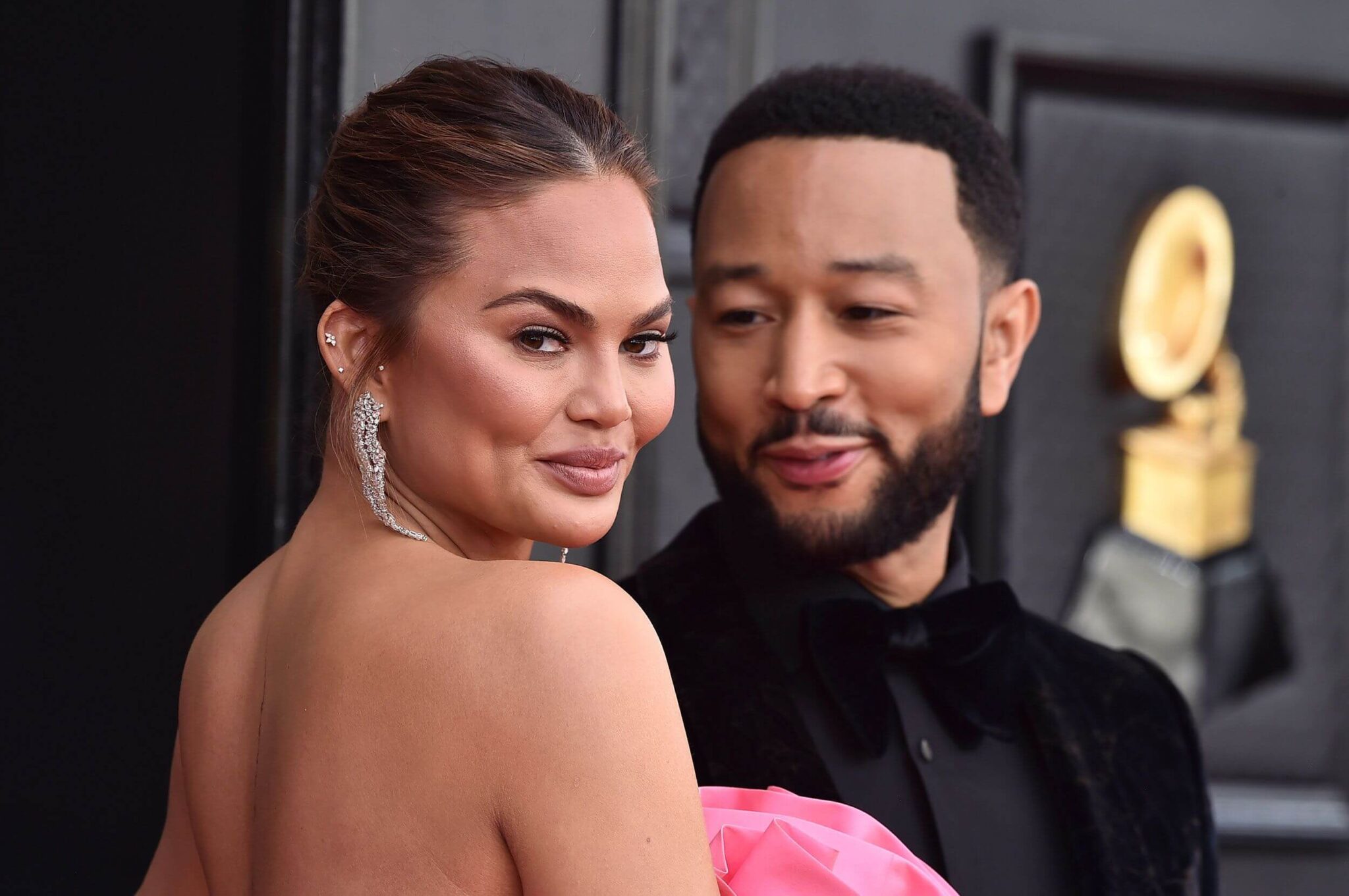 At the 2025 Grammys, Chrissy Teigen draws attention in an almost bare mesh gown alongside John Legend.
